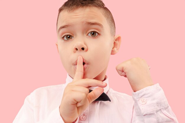 Cute elegant teen boy on pink background. Secret.