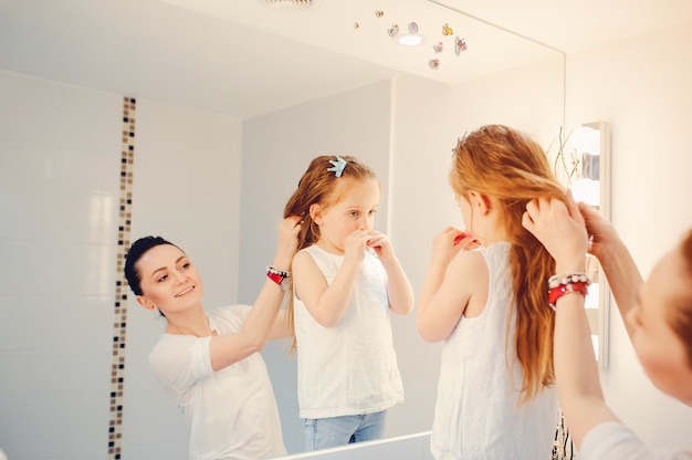 Cute family have fun in a bathroom