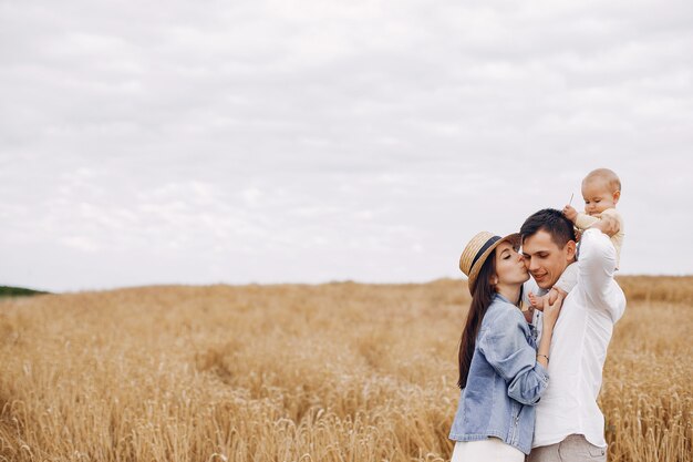 Cute family playing in an autumn field