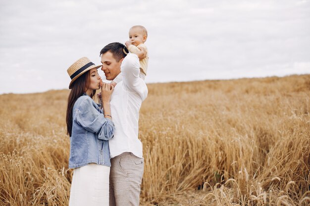 Cute family playing in an autumn field