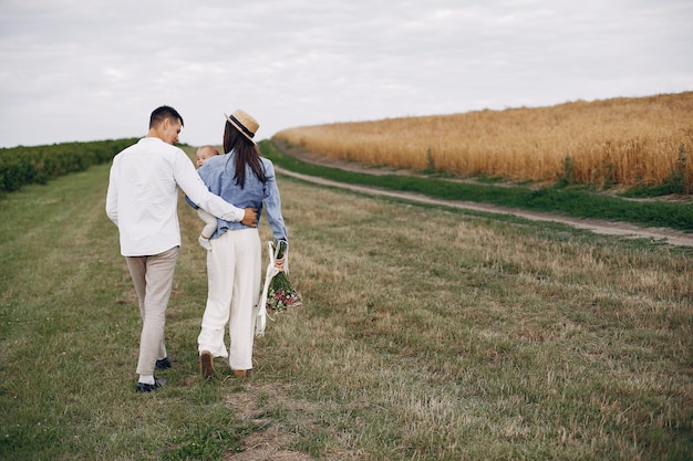 Cute family playing in an autumn field