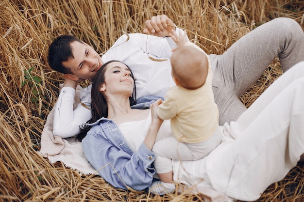 Cute family playing in an autumn field