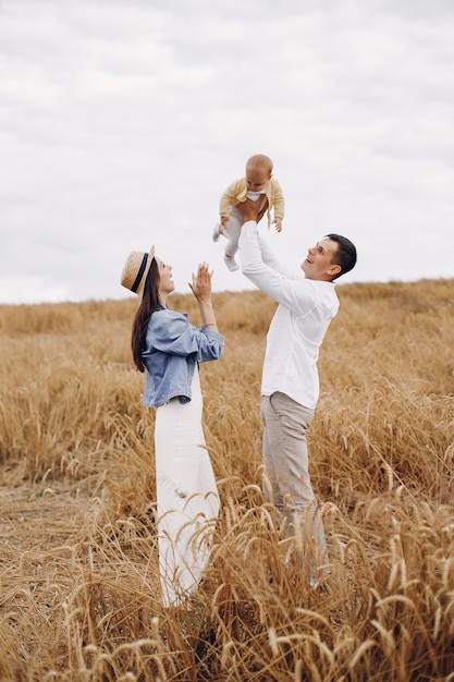 Cute family playing in a autumn field