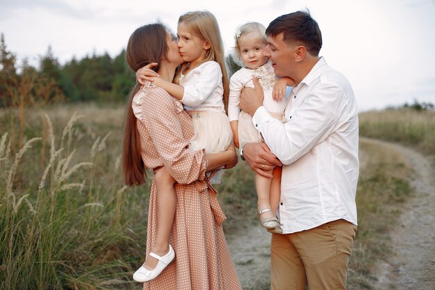 Cute family playing in a autumn field