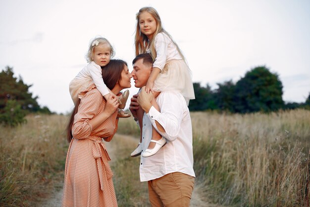 Cute family playing in a autumn field