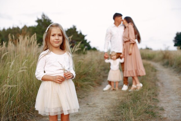 Cute family playing in a autumn field