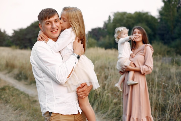 Cute family playing in a autumn field