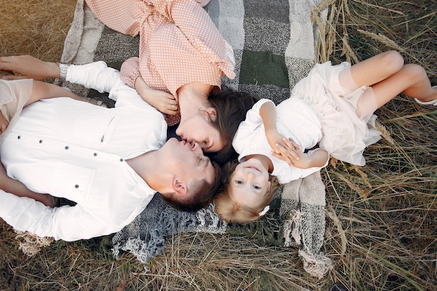 Cute family playing in a autumn field