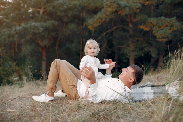 Cute family playing in a autumn field