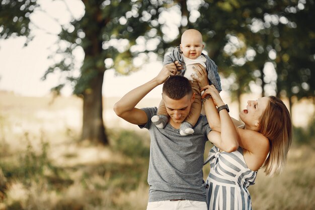 Cute family playing in a autumn field