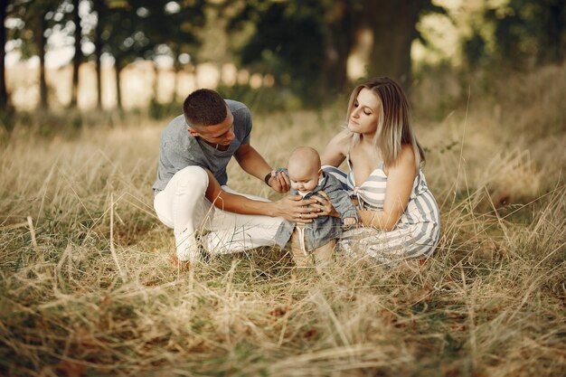 Cute family playing in a autumn field