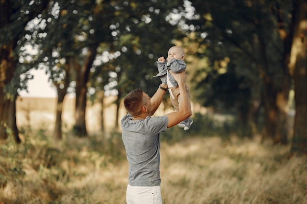 Cute family playing in a autumn field