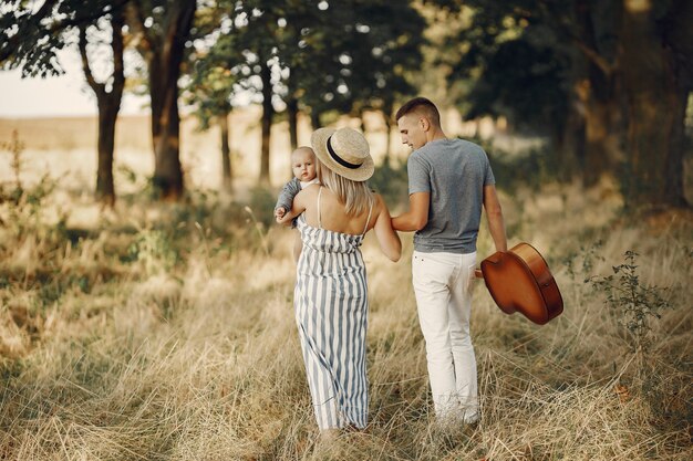 Cute family playing in a autumn field