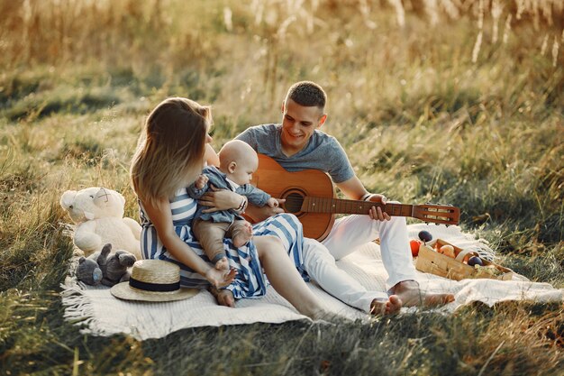 Cute family playing in a autumn field