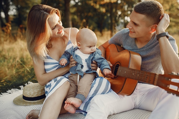 Cute family playing in a autumn field