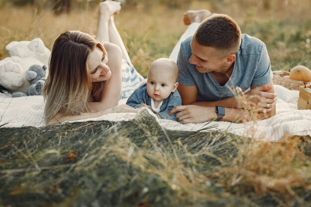 Cute family playing in a autumn field