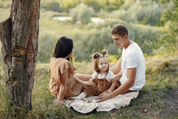 Cute family playing in a autumn field