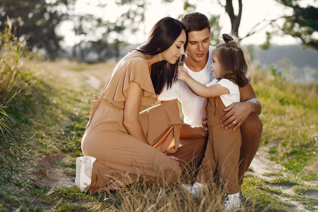 Cute family playing in a autumn field