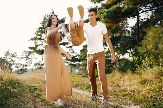 Cute family playing in a autumn field