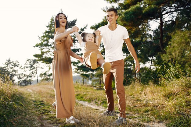 Free photo cute family playing in a autumn field