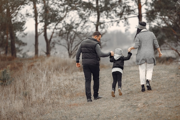 Famiglia sveglia che gioca in una foresta di primavera