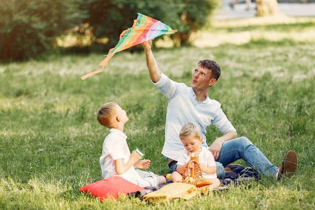 Free photo cute family playing in a summe field