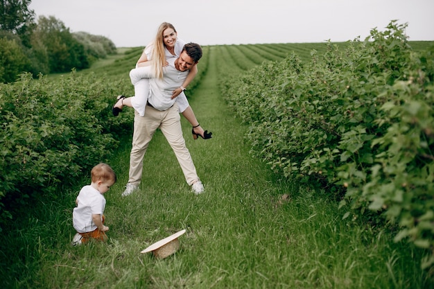 Free photo cute family playing in a summer field