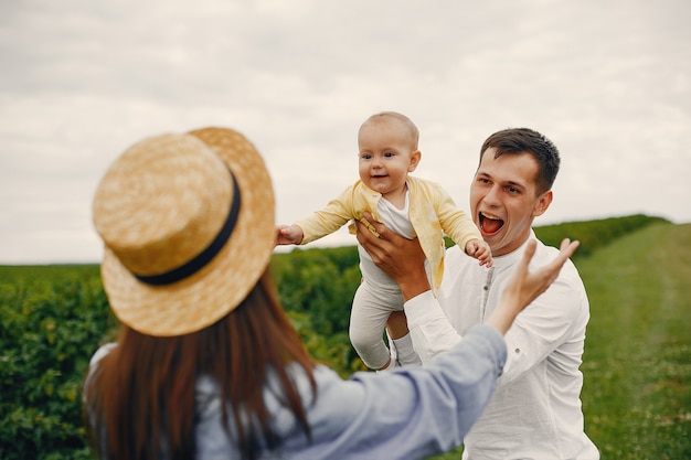 Cute family playing in a summer field