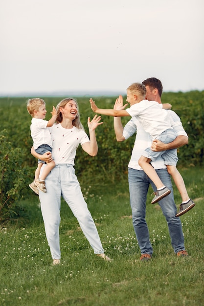 Free photo cute family playing in a summer field
