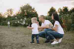 Free photo cute family playing in a summer field