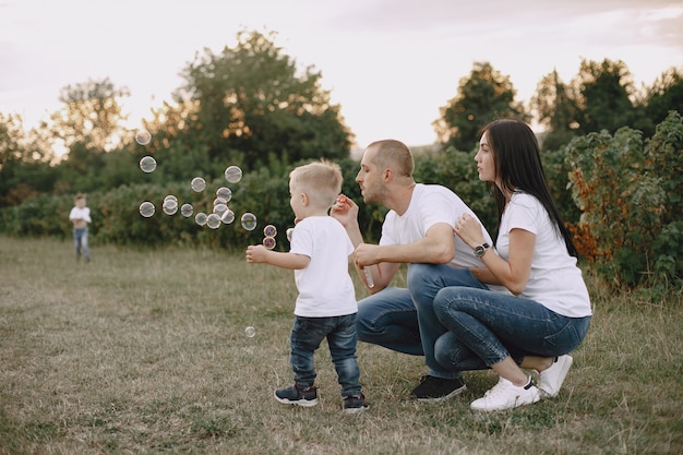 Cute family playing in a summer field