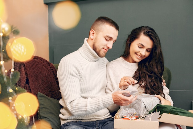 Cute family sitting at home near christmas tree