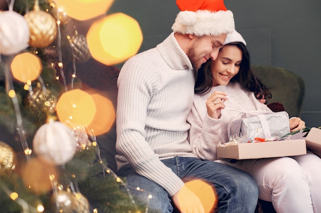 Cute family sitting at home near christmas tree