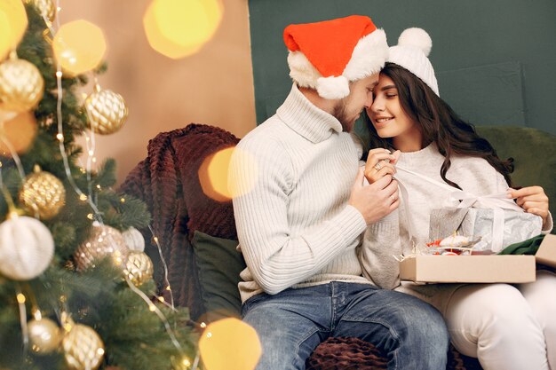 Cute family sitting at home near christmas tree