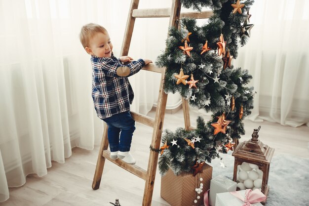 Cute family sitting near Christmas tree