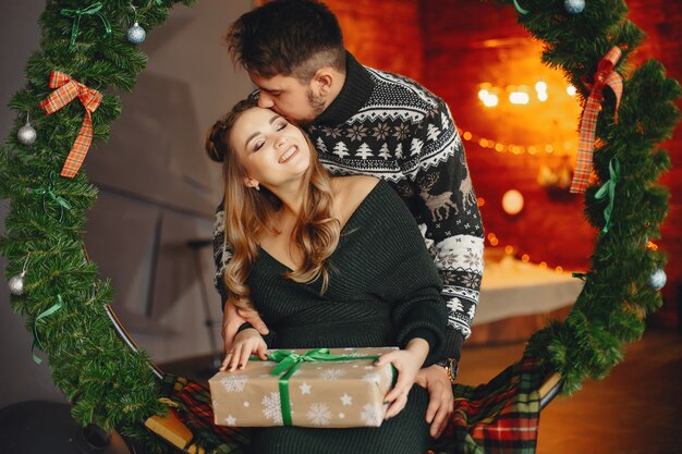 Cute family sitting near Christmas tree