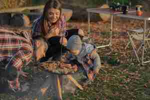 Free photo cute family sitting on a picnic in a forest