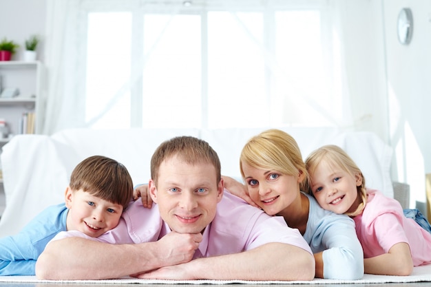 Cute family smiling together at home