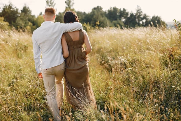 Cute family spending time in a summer field