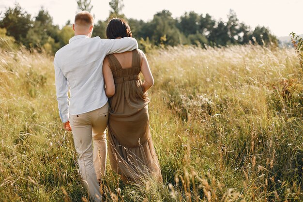 Cute family spending time in a summer field