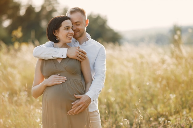 Cute family spending time in a summer field