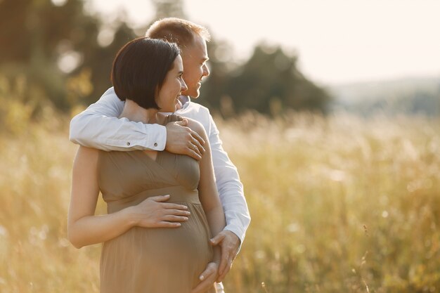 Cute family spending time in a summer field