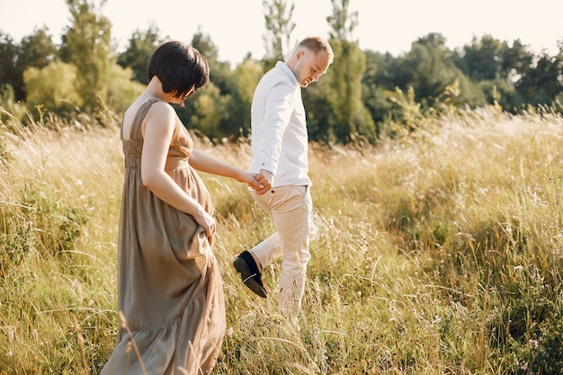 Cute family spending time in a summer field