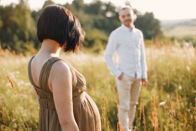 Cute family spending time in a summer field