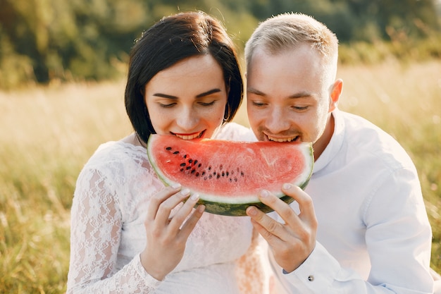 Free photo cute family spending time in a summer field