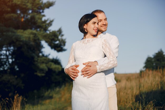 Cute family spending time in a summer field