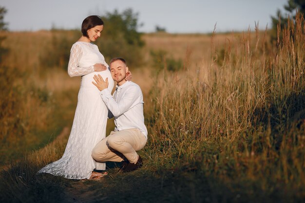 Cute family spending time in a summer field