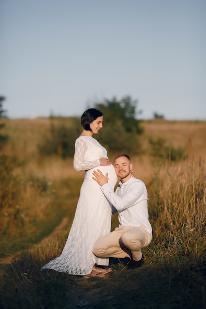 Cute family spending time in a summer field