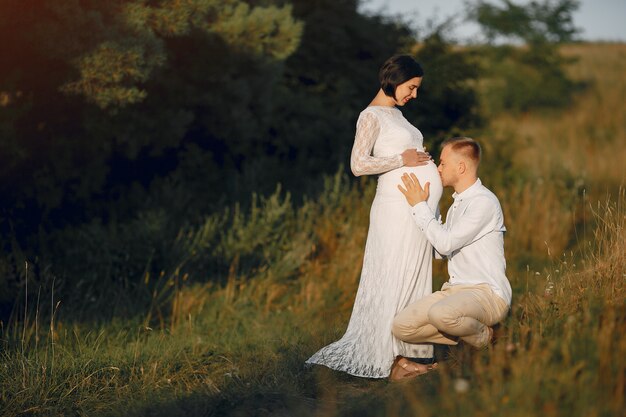 Cute family spending time in a summer field