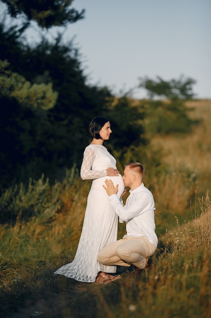 Cute family spending time in a summer field